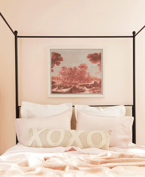 A striking bedroom vignette featuring a black four-poster bed frame and pink bedding.  The walls are painted in First Ligh 2102-70.