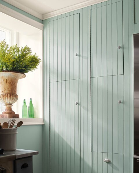 A kitchen vignette showcasing built-in tongue-and-groove cabinets painted in Raindance 1572.